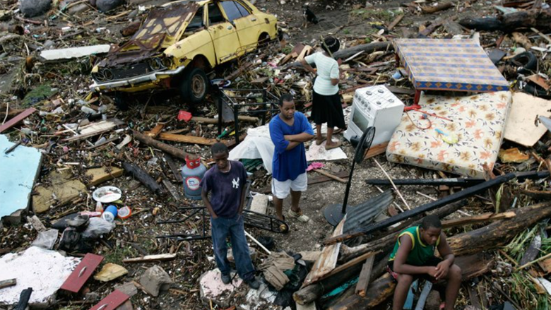 Residents of the coastal Bullbay neighborhood in Jamaica look over remains of their property, wiped out by Hurricane Dean.  P